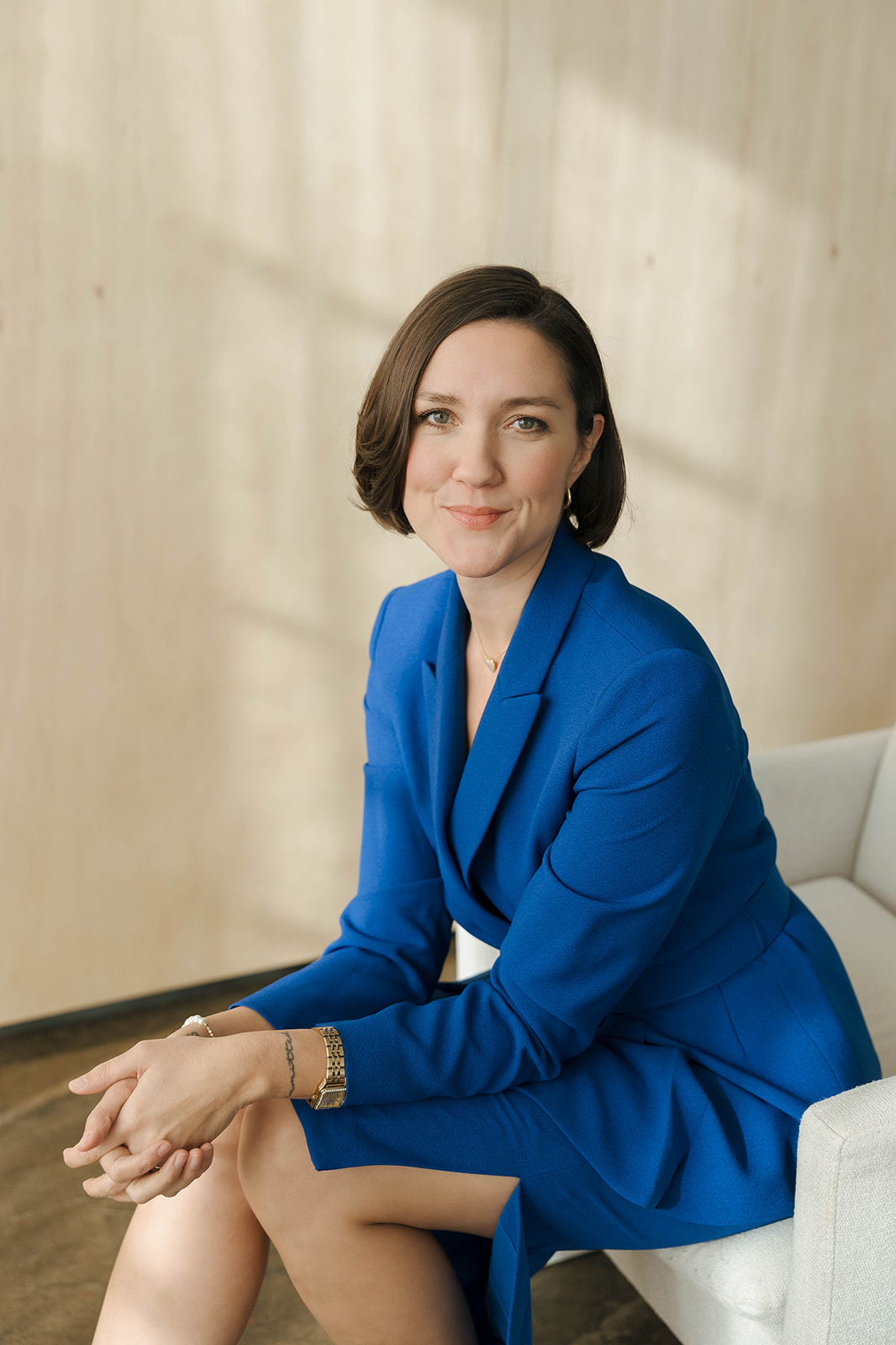Erin H. Robertson, seated, in a cobalt blue suit